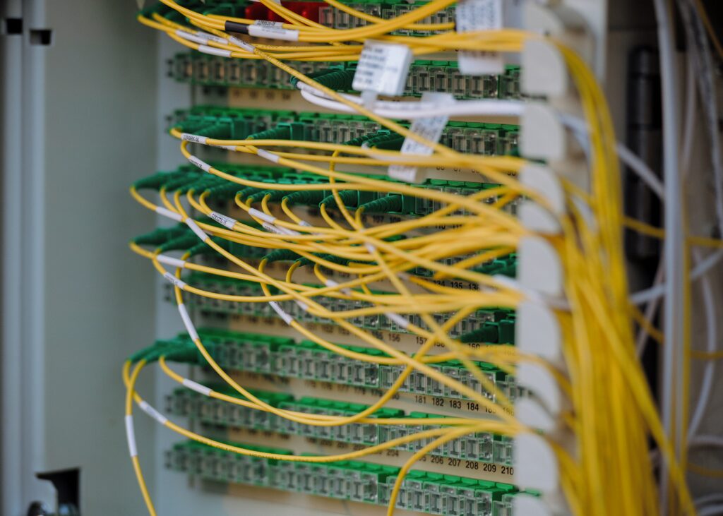 close up of electrical system comprised of many green plugins and yellow cords