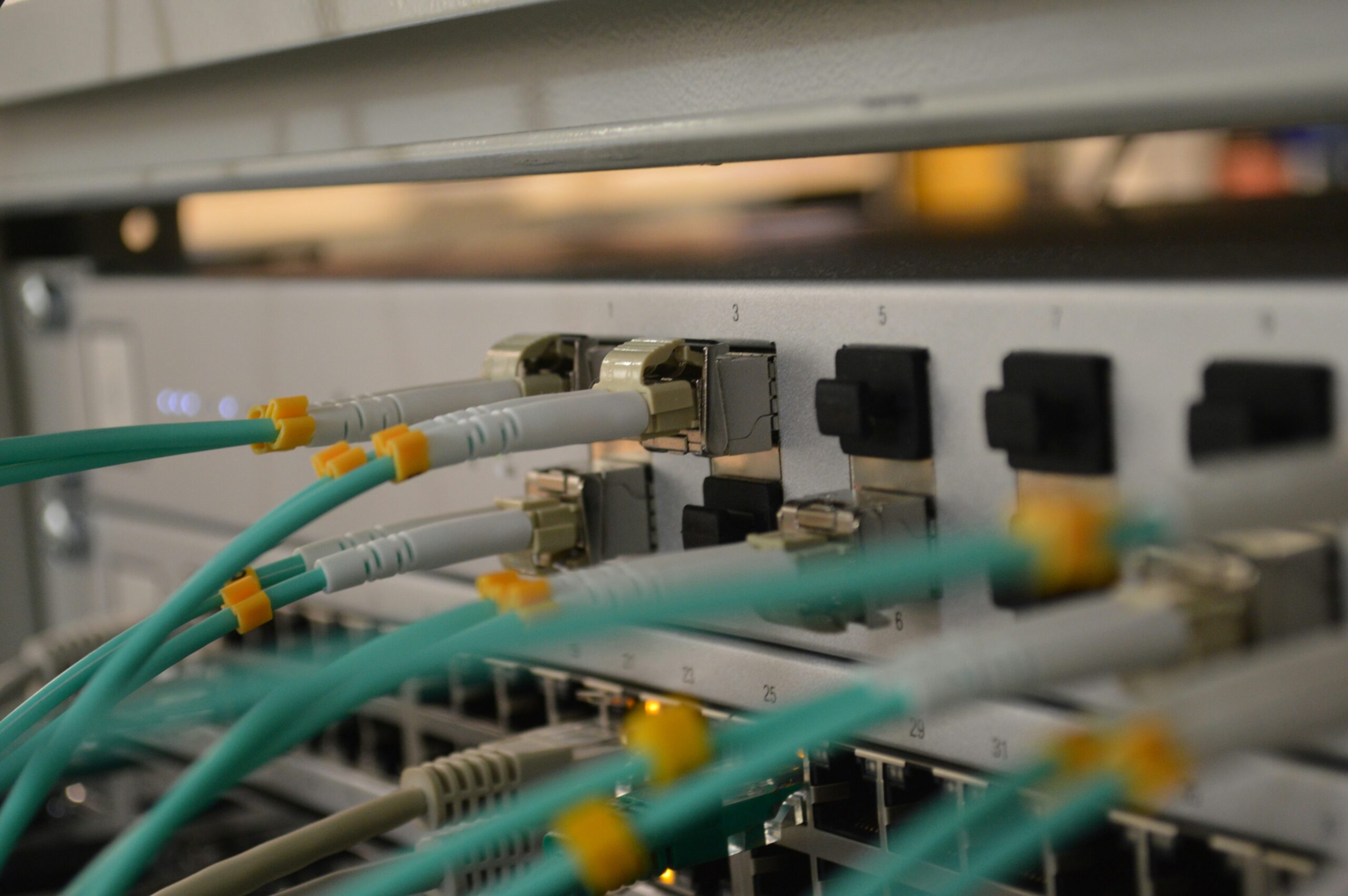 Close up of electrical system with 10 plugins and green cords connected to a few of them